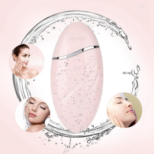 Pink skincare device with water droplets and faces on a pink background