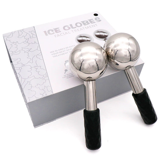 Two silver ice globes with black handles on a white background